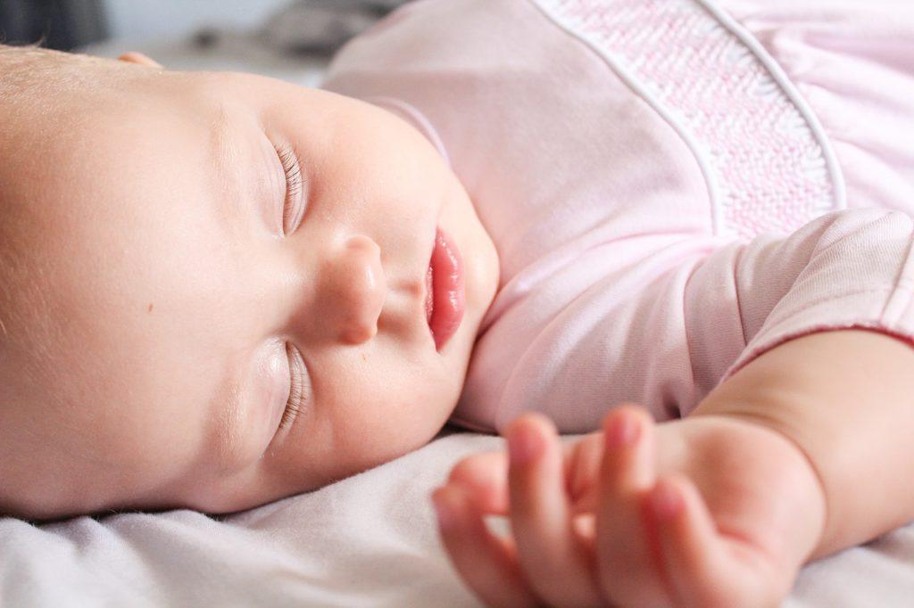 peaceful sleeping baby girl in pink