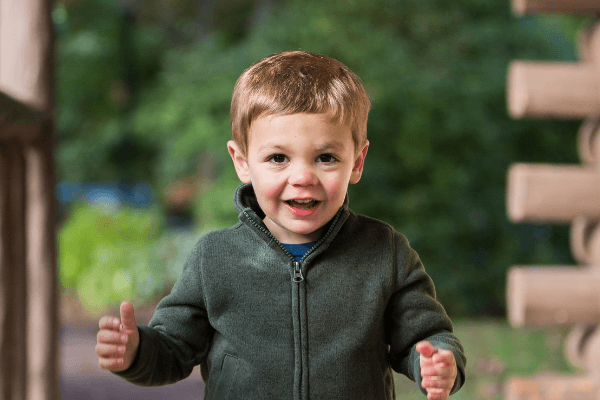 adorable baby boy standing outside