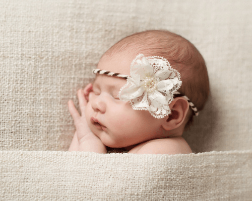 Elegant girl with flower headband sleeping