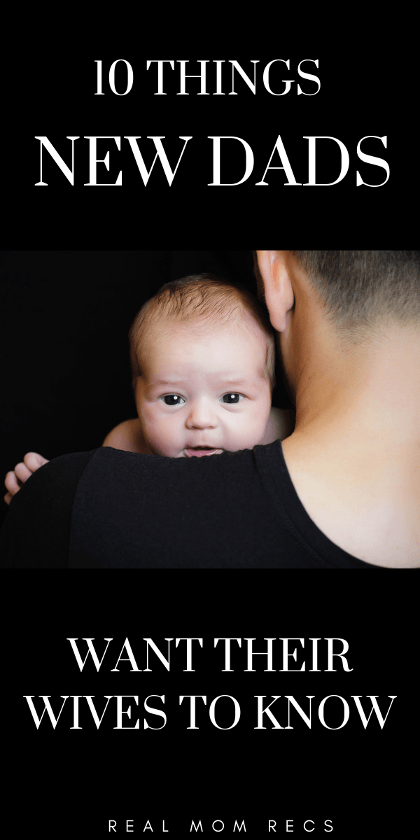 New dad holding baby over shoulder