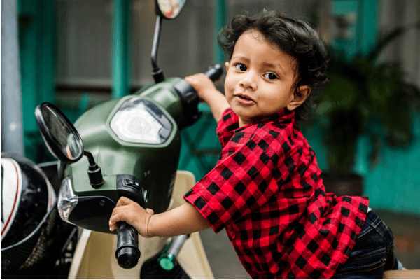 modern Hindu baby boy Indian on motorcycle