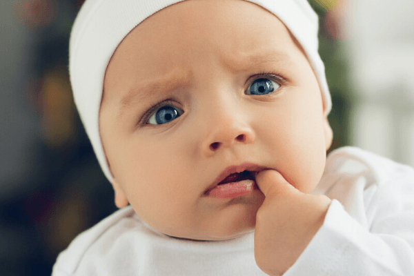 baby looking confused and worried over his misspelled name